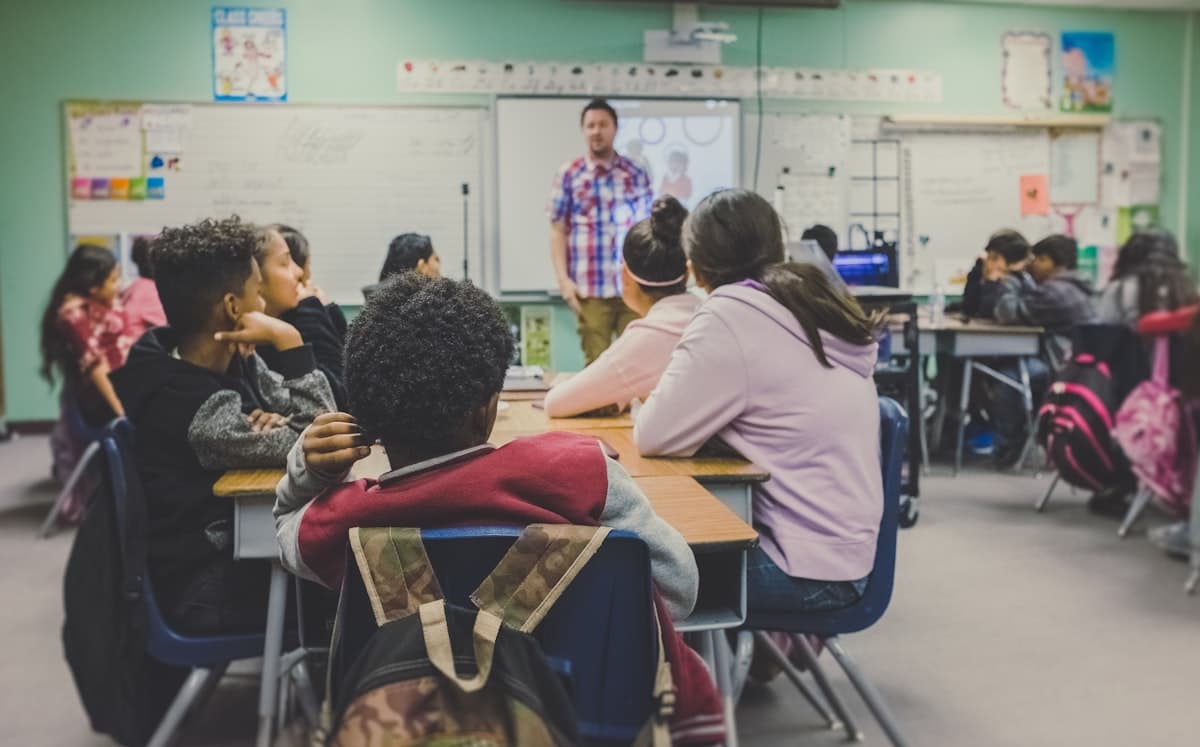 Teacher explaining at a whiteboard